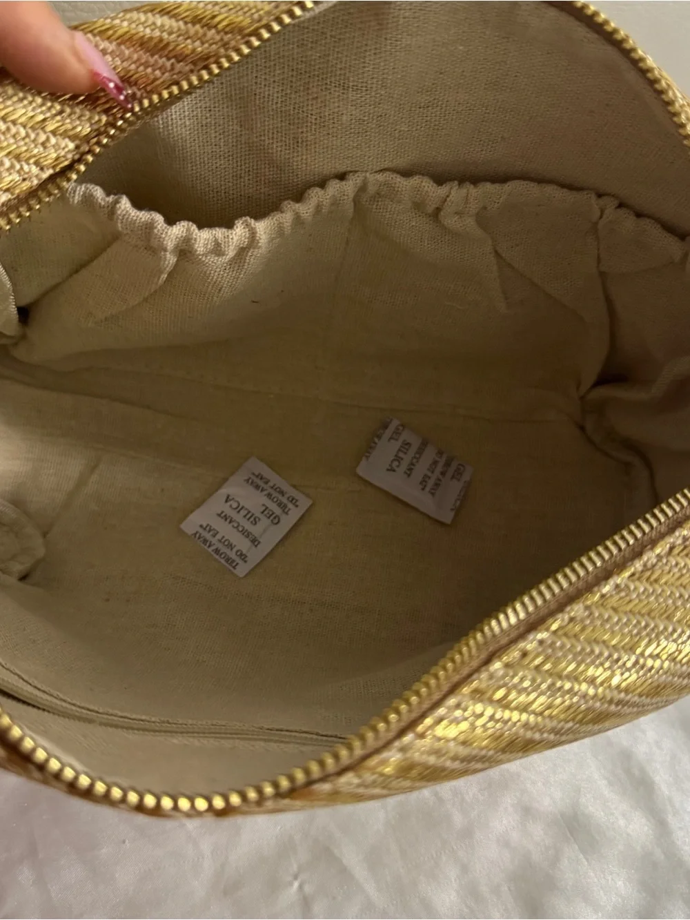 Vince Camuto gold woven canvas metallic cosmetic Bag with starfish Tassel charm.
